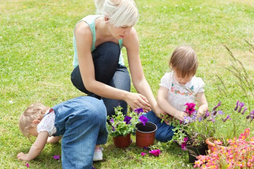 Low-maintenance garden with artificial grass and paving in Wealdstone